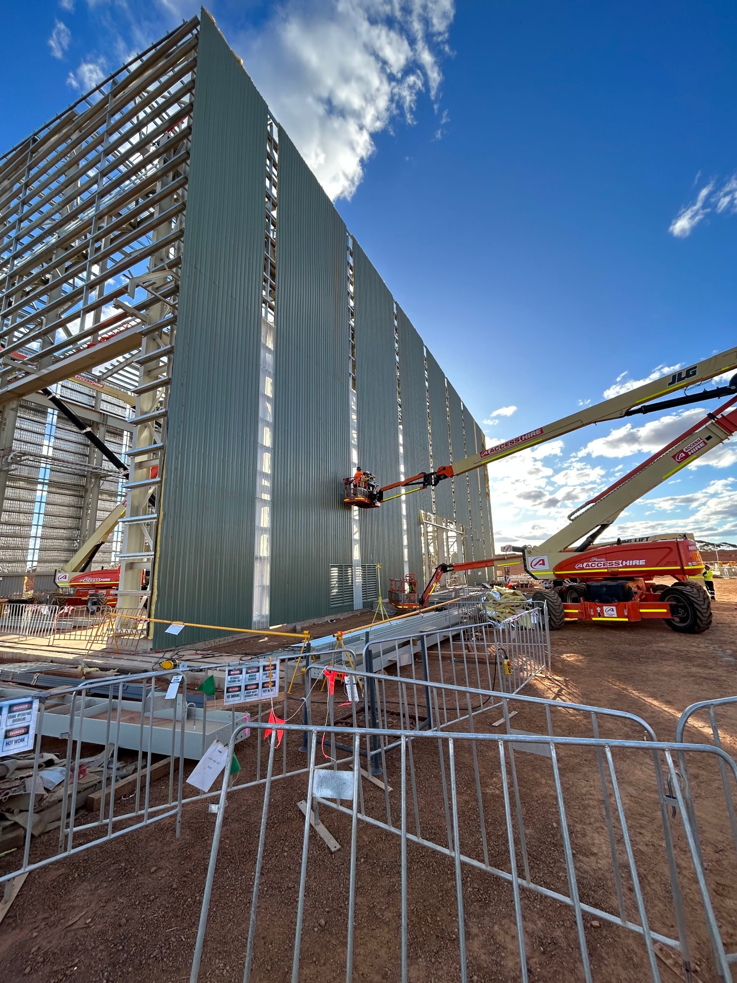 Close-up of standing seam metal cladding installation by a Hilton Roofing tradesperson